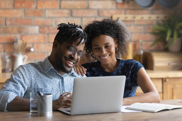 istock Happy young bonding african american family couple using computer. 1290323496