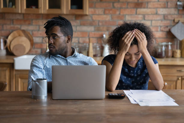 istock Stressed young married african ethnicity couple having financial problems. 1290323497