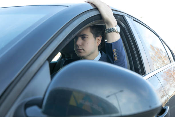 istock Businessman Driving Car, close up 1290325739