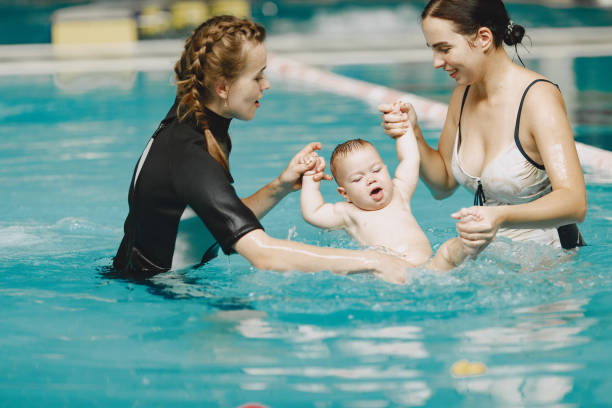 istock Mother and little son in a swimming pool 1290326035