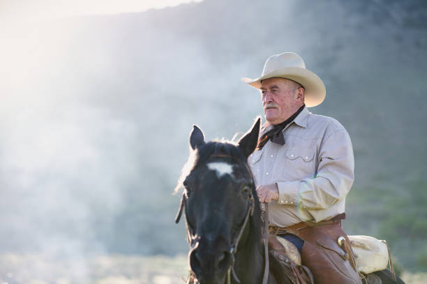 istock Senior cowboy on horseback 1290326391