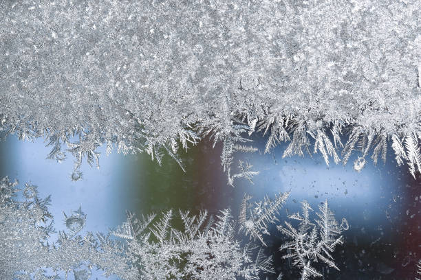 istock Abstract ice background, blue background with cracks on the ice surface. Frosty Christmas pattern on the winter window glass. Copy space, natural texture, macro 1290329186