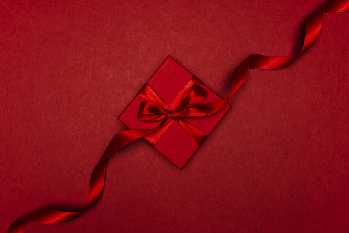 Red gift box on red, directly above.