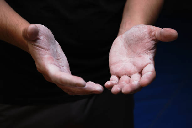 Male hands smeared with magnesium powder ready to workout