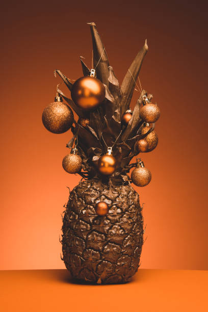 istock Golden pineapple with golden Christmas baubles. 1290332204