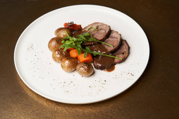 istock Baked pork and potatoes. Pork meat and vegetables 1290332828