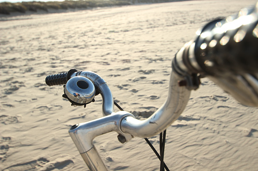 Old retro bicycle at the sandy beach which comes out on the North sea, at the island of Baltrum