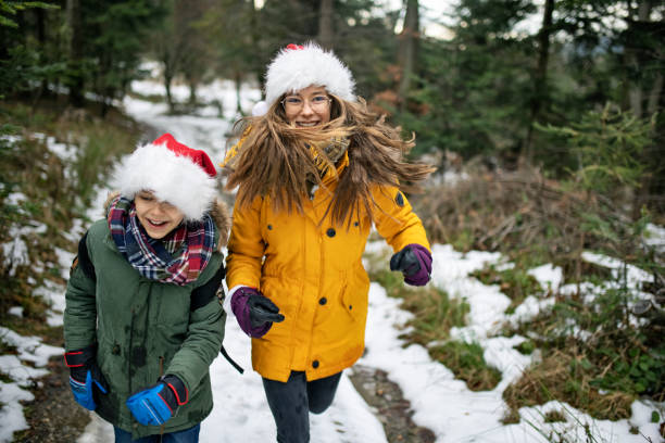 istock Brother and sister enjoying winter in forest. 1290333429