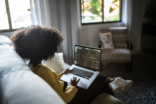 Teenager girl using laptop (studying or working) at home