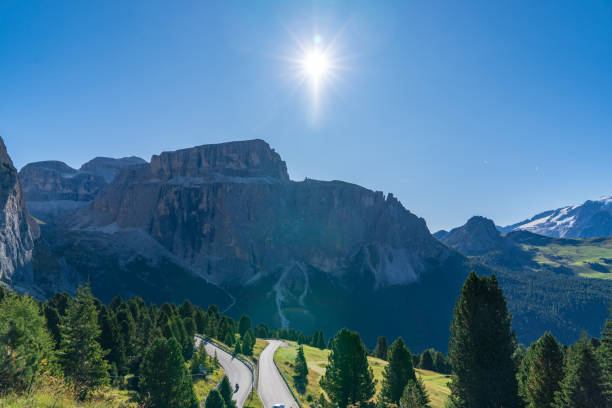 istock Green alpine meadows with huge mountains range on the background. 1290335433