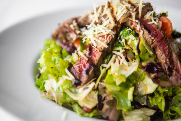 Beef steak salad on white plate Beef steak salad on white plate 3686 stock pictures, royalty-free photos & images