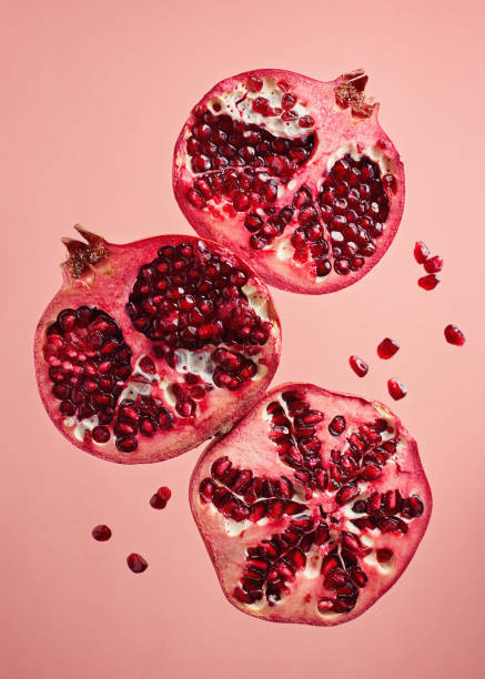 istock Close-Up Of Pomegranate Slices On Pink Background 1290335910