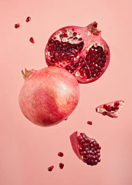 istock Close-Up Of Pomegranate Slices On Pink Background 1290335912