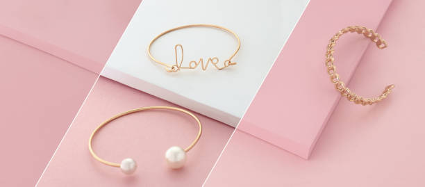 istock Golden modern bracelets on pink and white layout 1290338724