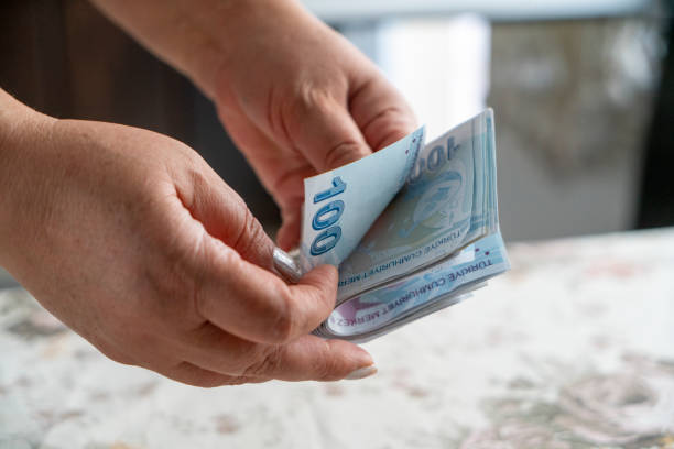 Adult female hand with Turkish Lira . The Turkish lira is counted. . accumulation at home and accumulation in old age stock photo