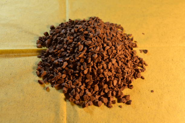 istock A handful of coffee on a yellow background. 1290339988