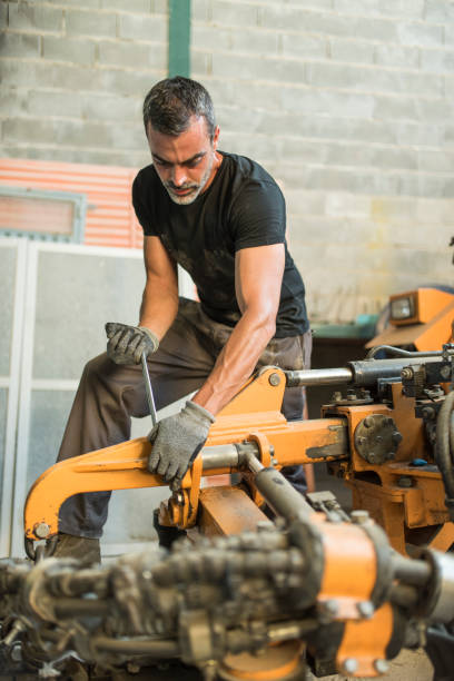 istock agricultural worker  repairing and adjusting bogey and performs maintenance 1290340008