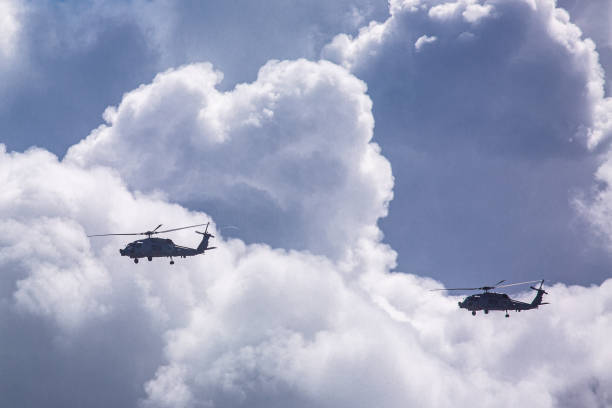 istock Military Helicopters flying through Storm Clouds 1290340464