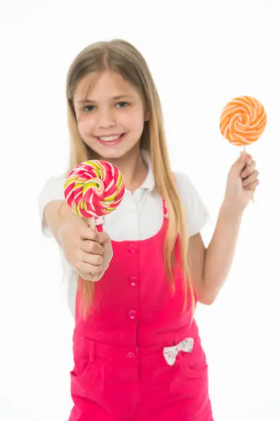 Little child smile with lollipops isolated on white. Happy girl hold candies. Sweet mood. Sharing candy with you.