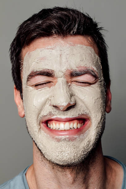 istock Smiling Caucasian Man Wearing a White Face Mask 1290344115