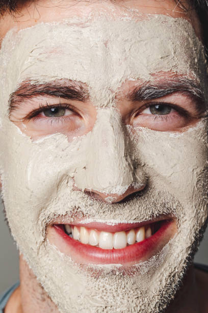 istock Smiling Caucasian Man Wearing a White Face Mask 1290344122