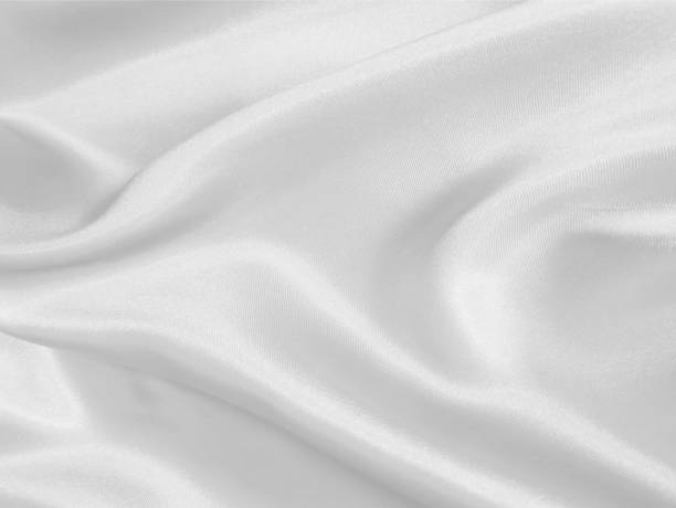 istock Shiny white crumpled fabric. Elegant cloth texture background 1290345007