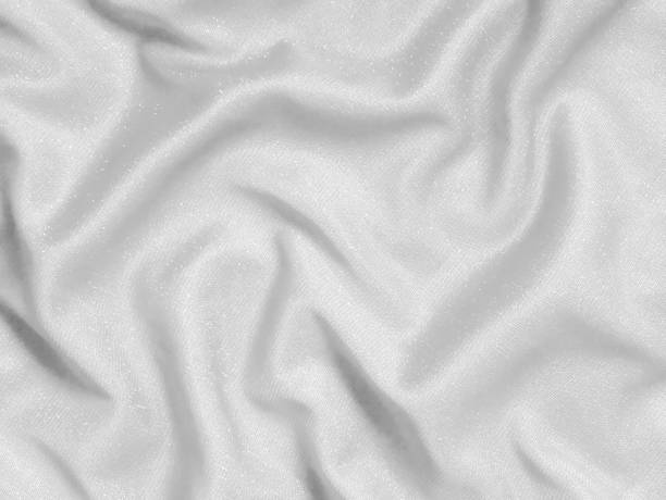 istock Shiny white crumpled fabric. Elegant cloth texture background 1290345097
