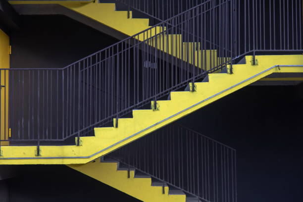 bright yellow external fire escape of new multilevel parking building bright yellow external fire escape of new multilevel parking building in city outdoor staircase stock pictures, royalty-free photos & images