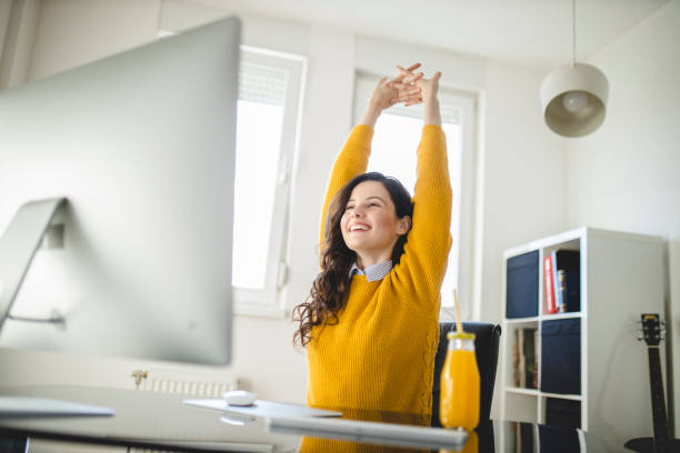 woman stretching and working at home - yoga business women indoors imagens e fotografias de stock