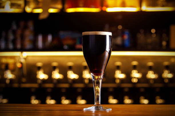 istock A glass of dark beer on a thin leg in a bar. 1290346449