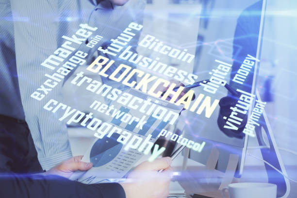 istock Crypto currency theme hologram with businessman working on computer on background. Concept of blockchain. Multi exposure. 1290347714