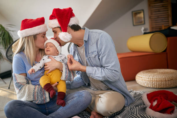 Happy wife and husband spending Chrismas together at home Happy wife and husband with baby spending Chrismas together at home mum new boyfriend stock pictures, royalty-free photos & images