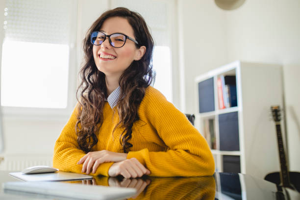 istock Portrait of young woman using computer and working at home 1290351010