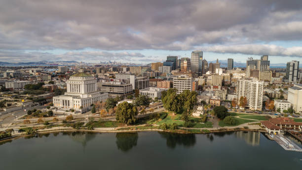 Downtown Oakland and Lake Merritt High Quality stock aerial photos of downtown Oakland with Lake Merritt in the foreground. oakland california stock pictures, royalty-free photos & images