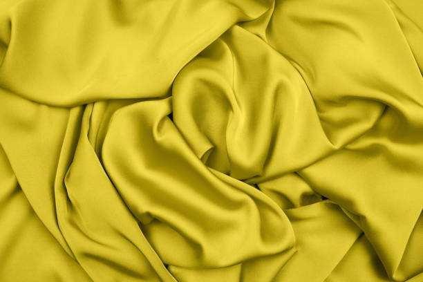 istock Knitted csilk wool texture yellow color. full frame background . close up. copy space. 1290358561