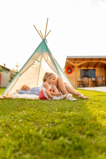 istock Mother and daughter camping in the backyard 1290359111