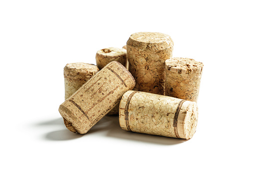 various corks from wine bottles on a white background