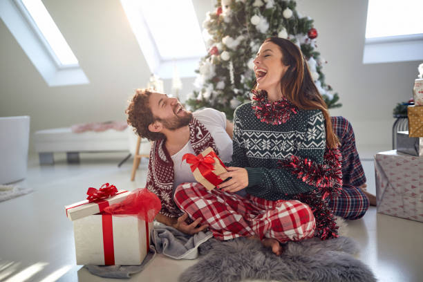 istock couple laughing at christmas morning 1290362643