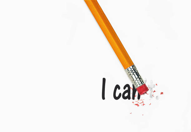 istock pencil erasing I Can't text to I Can on white paper 1290365998