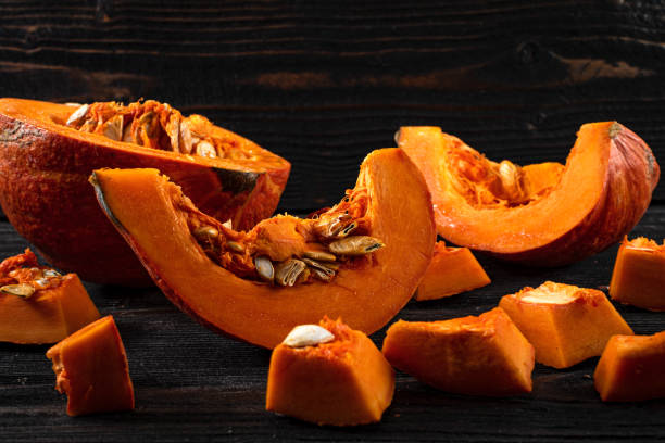 istock chop orange pumpkin on wooden table 1290366496