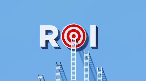 istock White Ladders Leaning on ROI Written Bull's Eye Target on Blue Wall 1290369896
