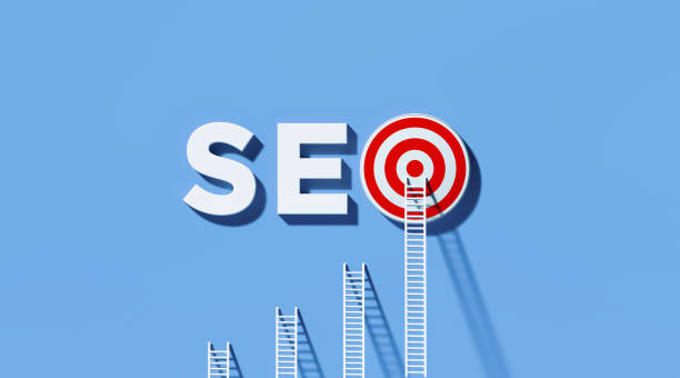 istock White Ladders Leaning on SEO Written  Bull's Eye Target on Yellow Wall 1290371034