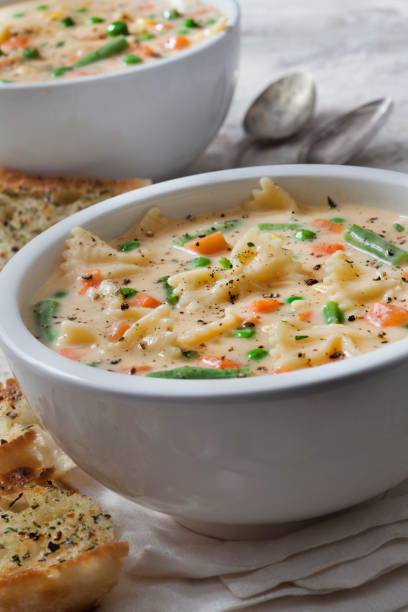 istock Creamy Macaroni and Cheese Soup with Bow Tie Pasta Garlic Bread 1290371115
