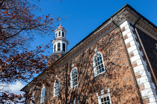 Alexandria, VA, USA 11-28-2020: Close up image of the historic Christ Church of Alexandria, Virginia. This brick colonial era building with arched palladin windows an a tower was buit in 1773 as the main Church of England in the neighborhood.