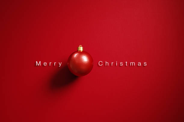 istock Christmas Concept-  Red Bauble and Merry Christmas Message on Red Background 1290373213