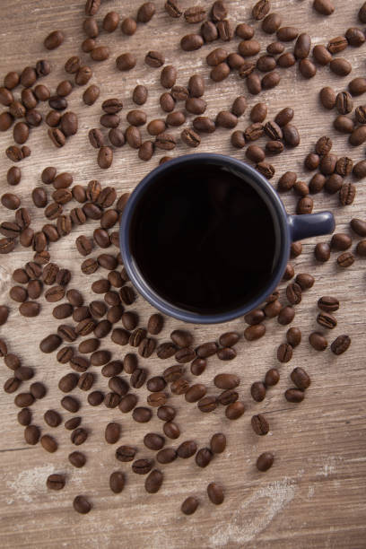 istock blue cup with coffee and beans around 1290379998