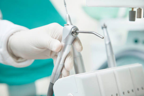 istock dentist with glove holding dental instruments 1290380489