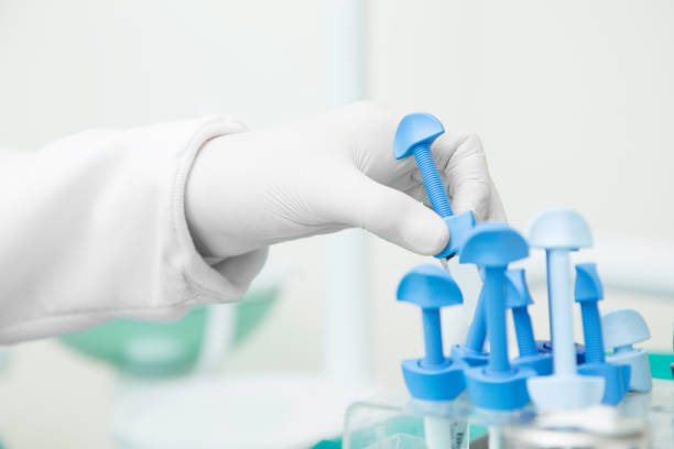white gloved hand holding medical tools