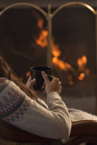 istock cup of hot chocolate with lit fireplace background 1290381621