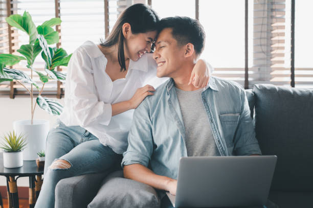happy Asian couple having a good time at home
